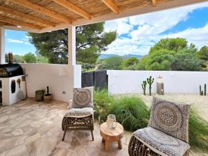 a patio with two chairs and a table at Spacious Retreat with Games in Benissa
