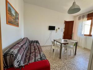 a living room with a table and a bed at Villa Pavone in Ginosa Marina