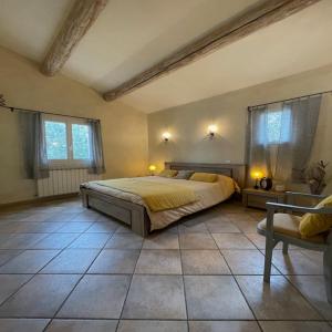 a bedroom with a bed and a tiled floor at villa provençale in Pierrevert