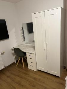 1 dormitorio con escritorio y 1 cama con espejo en Appartement Cormondrèche, en Neuchâtel