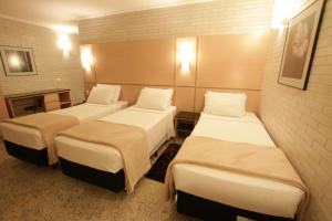 Postel nebo postele na pokoji v ubytování Hotel Confiance Centro Cívico