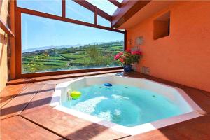 a hot tub in a room with a large window at 4 star holiday home in Los Realejos in Los Realejos