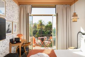 a hotel room with a bed and a balcony at Albert 1er in Nice