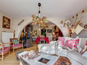 a living room filled with furniture and a chandelier at Holiday Home in Auvergne with Roofed Garden and Terrace in Calvinet