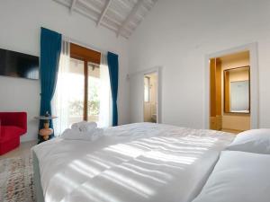 1 cama blanca grande en un dormitorio con ventana en Stylish Villa with Bomb Shelter Close to Shore, en Cesarea