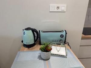 a coffee maker and a toaster on a table at Apartamentos TARELA Porriño in Porriño