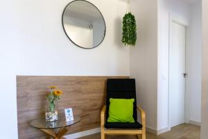 a room with a mirror and a chair and a table at Mijas Sea Views Apartment in Mijas Costa