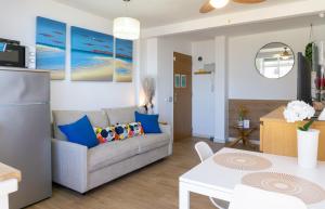 a living room with a couch and a table at Mijas Sea Views Apartment in Mijas Costa