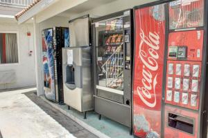 two cocacola machines are lined up in a store at Motel 6-Lancaster, CA in Lancaster