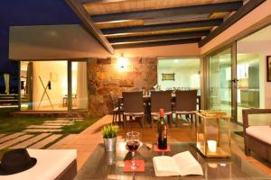 a living room with a table with a bottle of wine at Holiday Home Maspalomas - LPA03100b-F in Maspalomas