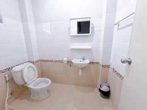 a bathroom with a toilet and a sink at The Room Relax in Ban Chang