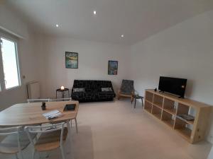 a living room with a couch and a table at Aix-les-bains centre, 2 ch, 4 pers, climatisé in Aix-les-Bains