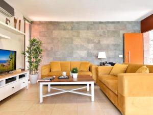 a living room with a couch and a table at Holiday Home Maspalomas - LPA03100h-O in Maspalomas
