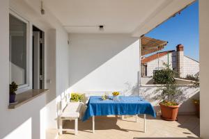 uma mesa com uma toalha de mesa azul numa varanda em Charming view old town ap, with free parking em Dubrovnik