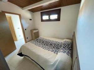 a bedroom with a bed and a window at Casa Divarro in O Grove