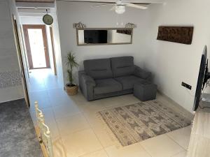 a living room with a couch and a television at Casa Divarro in O Grove