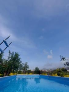 a swimming pool with a view of the mountains at Villa Nadira in Giardini Naxos