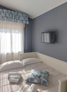 a bedroom with a large bed with two pillows on it at Villa Nadira in Giardini Naxos