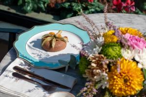a plate with a pineapple on a table next to flowers at MFB Tarabya Hotel in Istanbul