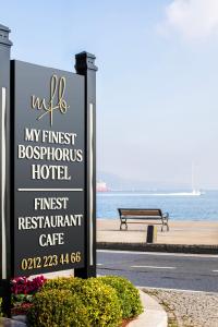 een bord voor een hotel naast een bankje bij MFB Tarabya Hotel in Istanbul