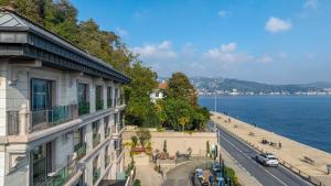a view of a building and a street next to the water at MFB Tarabya Hotel in Istanbul
