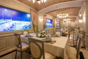 a restaurant with white tables and chairs and a large window at MFB Tarabya Hotel in Istanbul