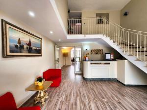 a living room with a staircase and a red couch at Hotel Nazionale in Bolsena