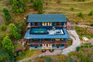 an aerial view of a house with a green roof at StayVista at Leopard's Creek with Pool in Solan