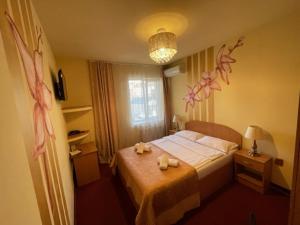 a hotel room with a bed with towels on it at Pensiunea Ileana in Sibiu