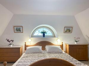a bedroom with a large bed with a window at Achtern Diek 7b - Wohnung 8 in Groß Kirr