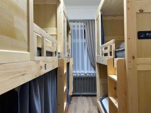 a room with wooden bunk beds with a window at Shisandufu Youth Hostel in Xi'an