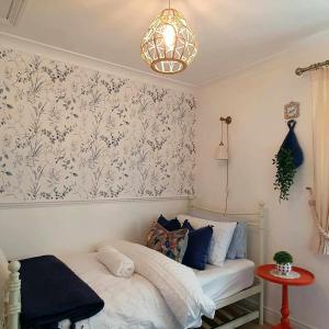 a bedroom with a bed and a chandelier at Beatrice Cottage in Richmond