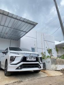 a white car parked in front of a building at Homestay Defaza D48 Garut in Garut