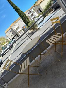 a yellow chair sitting on the side of a building at Agde Studio proche Plage in Agde