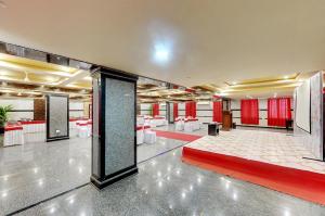 a large room with tables and red curtains in a building at Hotel Vista Suites, Bangalore in Bangalore