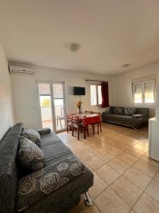 a living room with a couch and a table at Perica Apartments in Zadar