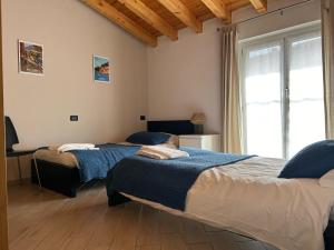 a bedroom with two beds and a window at Menaggio Down Town in Menaggio