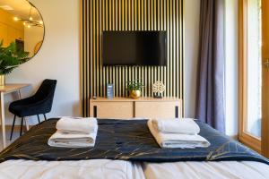 sypialnia z łóżkiem z ręcznikami w obiekcie Podhalańskie Uroki by Apart Concept Podhale w mieście Kościelisko