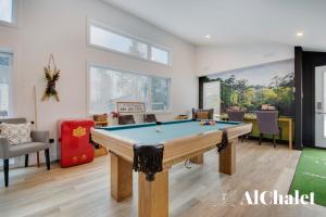 a room with a pool table in it at Achille - Wooded with spa and sauna in Pont-Rouge