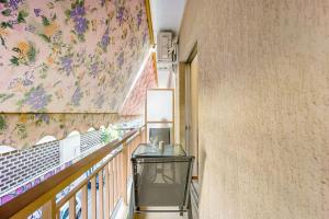 a hallway with a table and a wall with flowers at Top Acropolis Sightseeing 1st FLR Elegant Flat by LODGESPOT in Athens