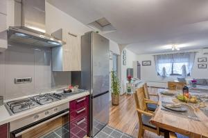 a kitchen and dining room with a table and a counter at Apartments Suki in Rovinj