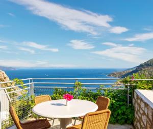 a table and chairs on a balcony with a view of the ocean at Loryma Resort Hotel in Turunç