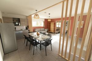 a kitchen and dining room with a table and chairs at Lagocéan in Vieux-Boucau-les-Bains
