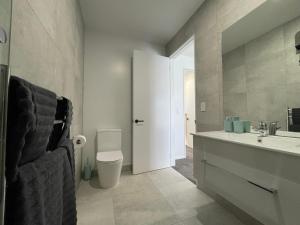 a bathroom with a sink and a toilet and a sink at Stadium View Suite in Christchurch +40 photos
