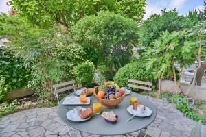 a table with a basket of fruit on it at Fully equipped beach studio in Cagnes-sur-Mer