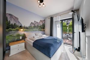 a bedroom with a bed with a view of a river at RentPlanet - Apartament Franciszkańska in Szklarska Poręba