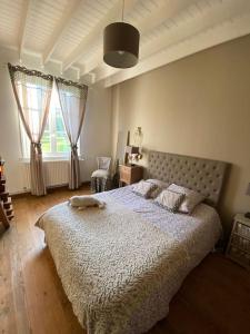 a bedroom with a large bed and two windows at Aux couleurs de la Baie à Sailly-Bray in Noyelles-sur-Mer