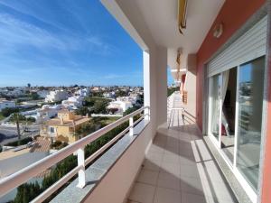 a balcony with a view of a city at 3Z Brisa Mar - Casas & Papéis in Armação de Pêra