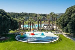 a pool in a park with a water slide at Kresten Palace Hotel in Kallithea Rhodes