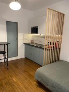 Cette chambre comprend un lit, une cuisine et une table. dans l'établissement Studio Paris tour Eiffel, à Paris